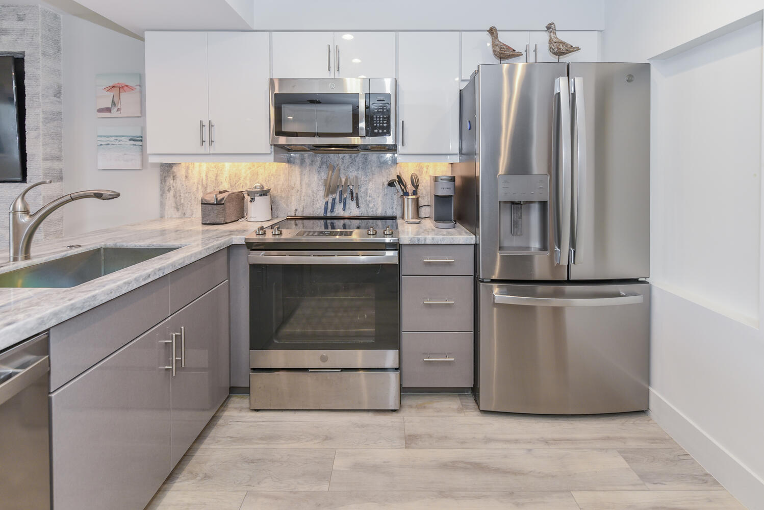 1605 Highway 1, Unit B302 Jupiter, FL 33477 - Photo 29 of 47 a kitchen with appliances a sink and cabinets