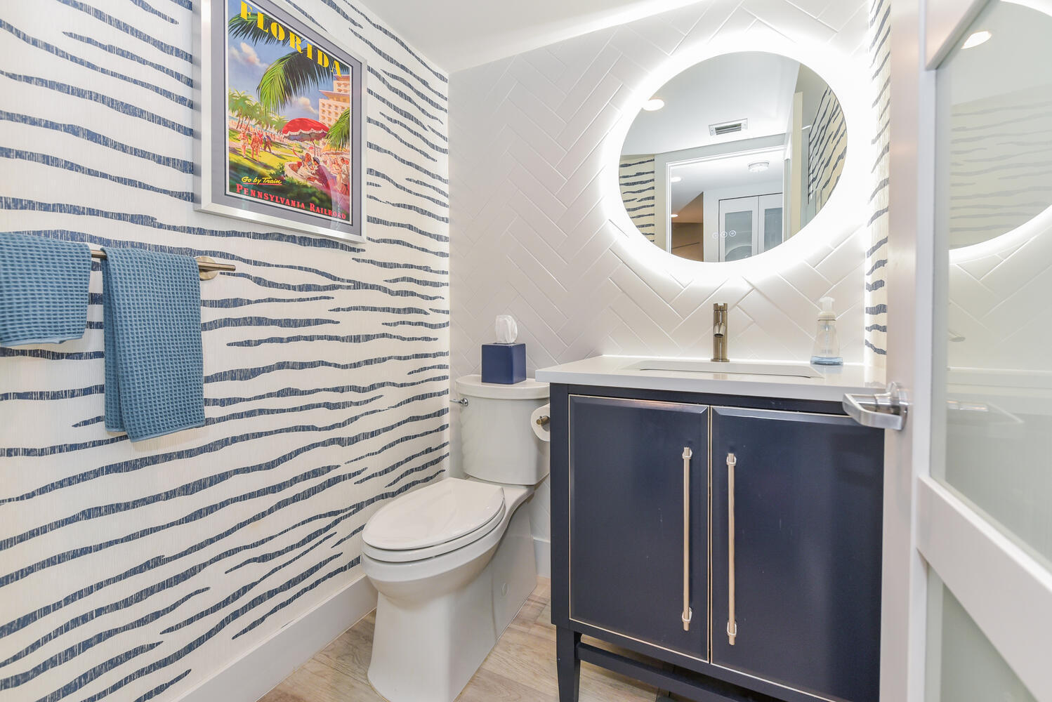 1605 Highway 1, Unit B302 Jupiter, FL 33477 - Photo 30 of 47 a bathroom with a sink a toilet and mirror