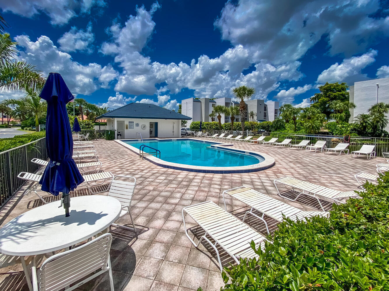1605 Highway 1, Unit B302 Jupiter, FL 33477 - Photo 39 of 47 a swimming pool with barbeque oven outdoor seating and yard