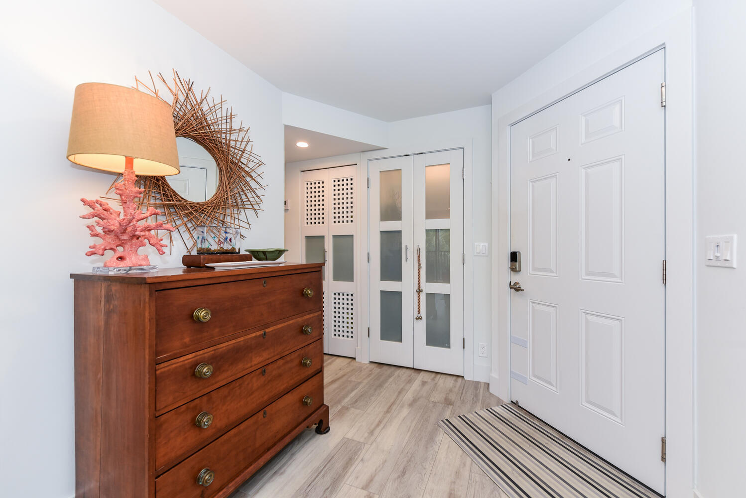 1605 Highway 1, Unit B302 Jupiter, FL 33477 - Photo 4 of 47 a room with a dresser and a mirror