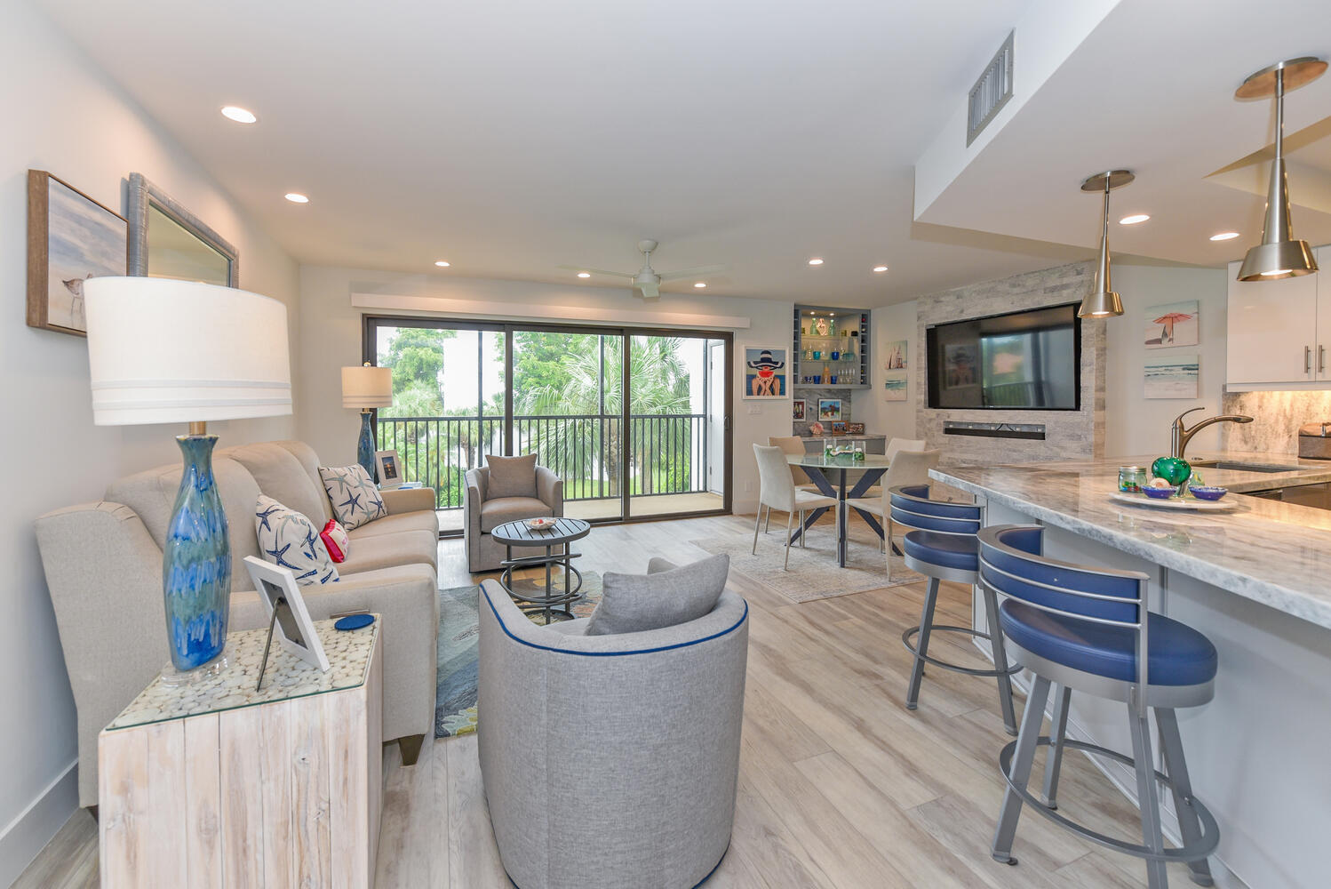 1605 Highway 1, Unit B302 Jupiter, FL 33477 - Photo 7 of 47 a living room with furniture a large window and a flat screen tv