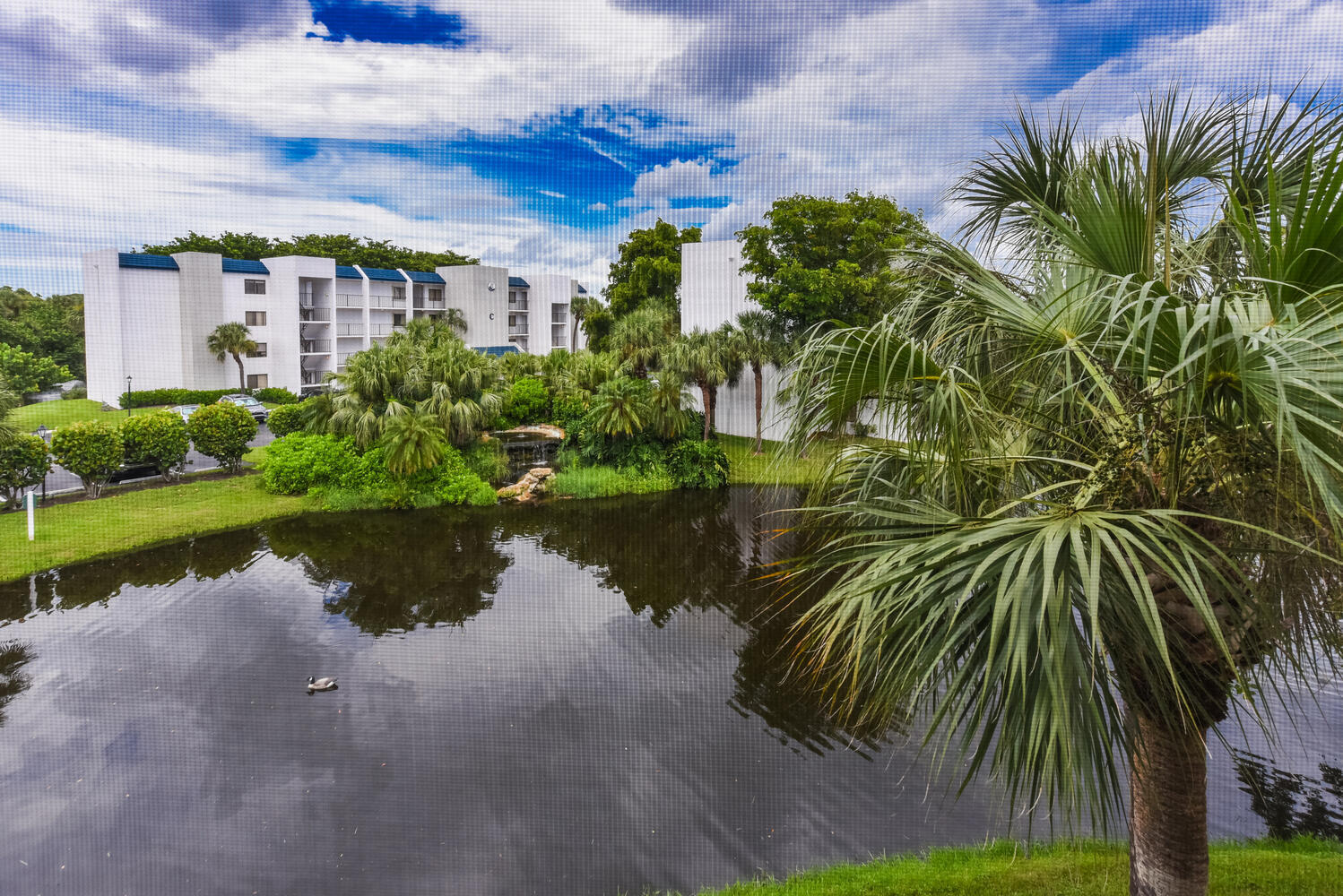 1605 Highway 1, Unit B302 Jupiter, FL 33477 - Photo 10 of 47 a view of a lake with a building in the background