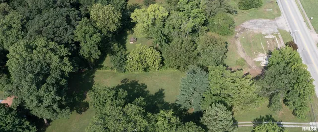 an aerial view of a house with yard