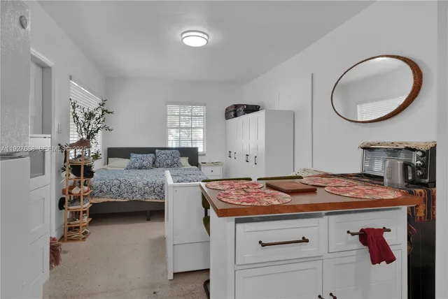 a bedroom with bed and a mirror