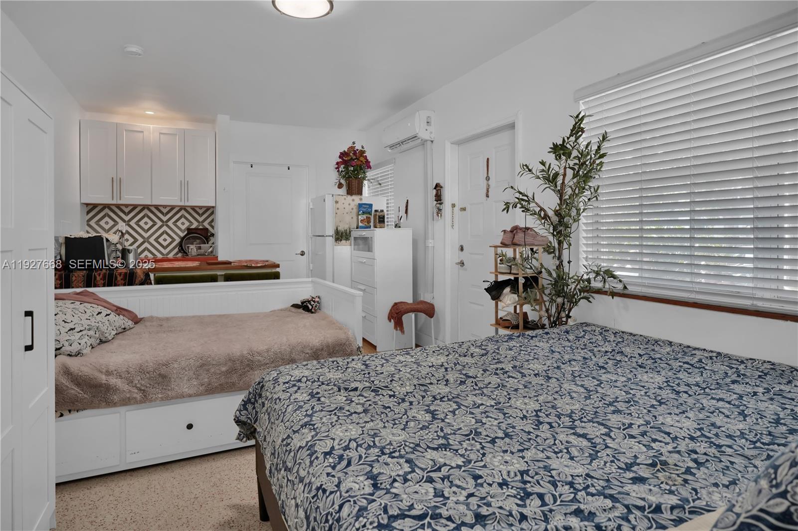 601 Southwest 6th Avenue Miami, FL 33130 - Photo 9 of 20 a bedroom with a bed and a potted plant