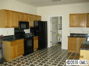 3019 White Store Road Wingate, NC 28174 - Photo 5 of 8 a kitchen with a sink a refrigerator and cabinets