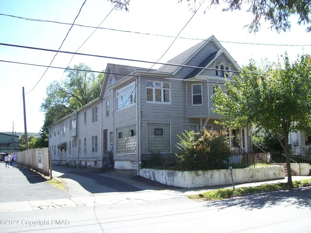 a front view of a house with garage and glass windows