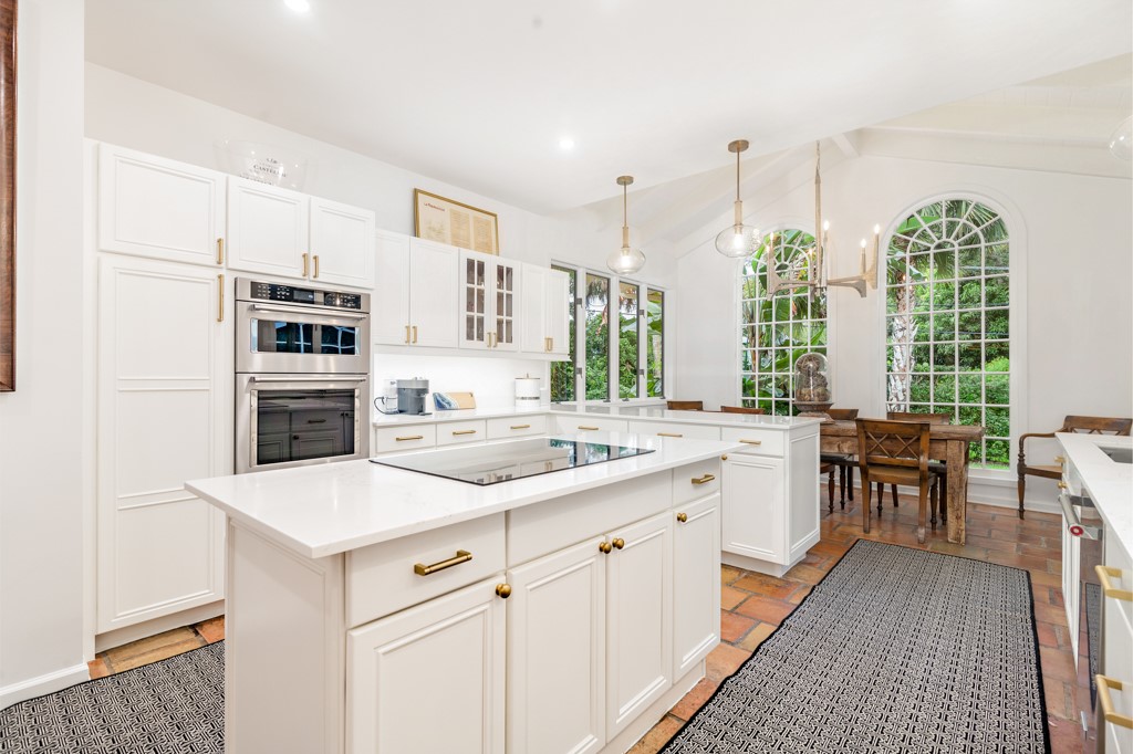1513 East Camino Del Rio Vero Beach, FL 32963 - Photo 11 of 36 a open kitchen with stainless steel appliances granite countertop a stove a sink dishwasher and a refrigerator with wooden floor