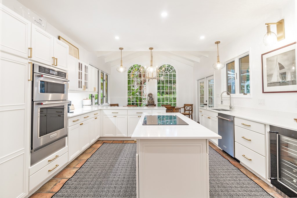 1513 East Camino Del Rio Vero Beach, FL 32963 - Photo 12 of 36 a kitchen that has a lot of white cabinets and stainless steel appliances