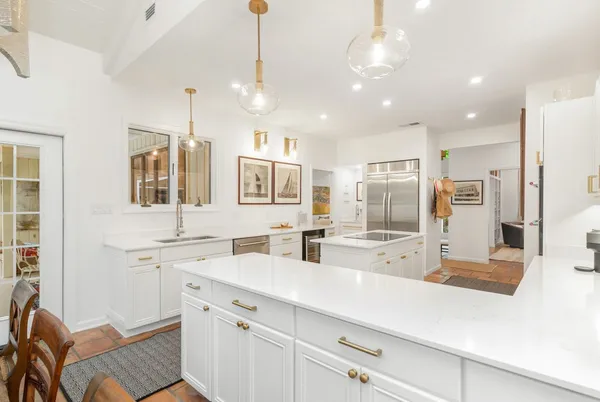 a kitchen with stainless steel appliances a sink stove and refrigerator