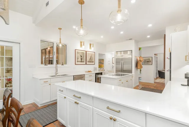 a kitchen with stainless steel appliances a sink stove and refrigerator