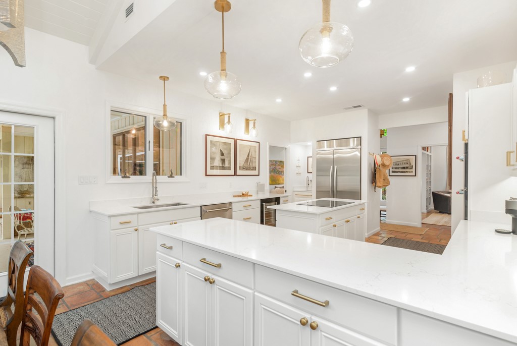 1513 East Camino Del Rio Vero Beach, FL 32963 - Photo 14 of 36 a kitchen with stainless steel appliances a sink stove and refrigerator