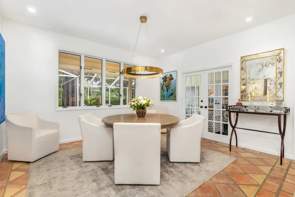 a view of a dining room with furniture a chandelier and wooden floor