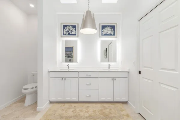 a bathroom with a toilet sink and mirror