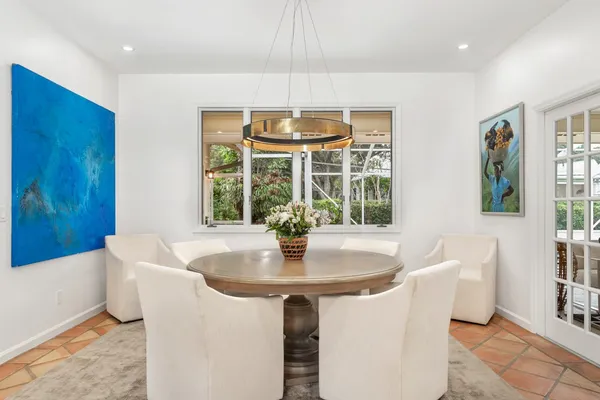 a dining room with table chairs and chandelier