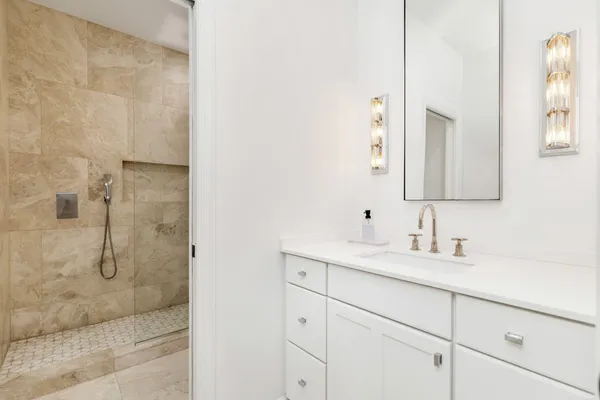 a bathroom with a double vanity sink mirror and