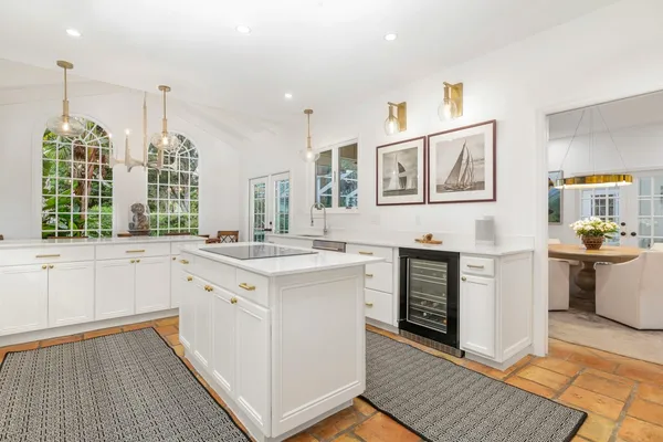 a kitchen with a stove sink and cabinets