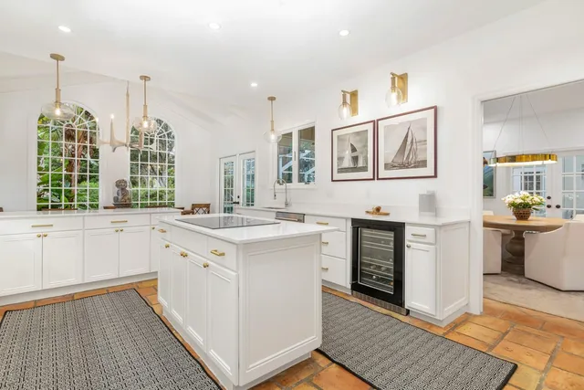 a kitchen with a stove sink and cabinets