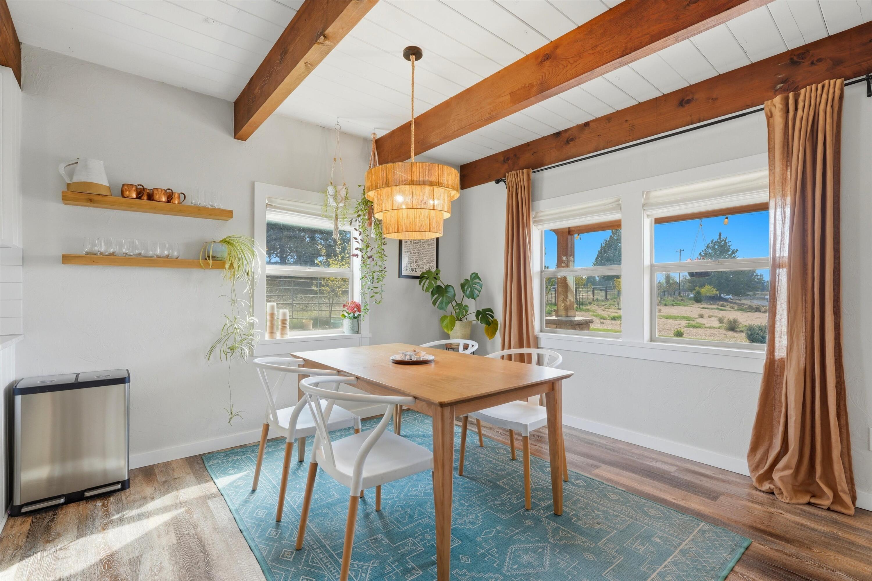 61280 Larsen Road Bend, OR 97702 - Photo 17 of 58 a dining room with furniture and wooden floor