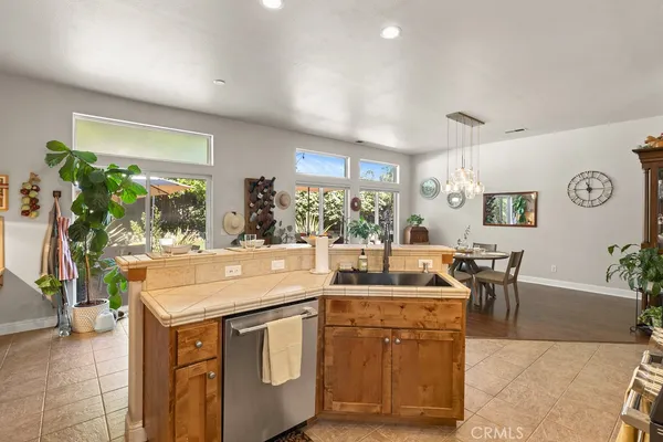 a kitchen with a sink and chairs
