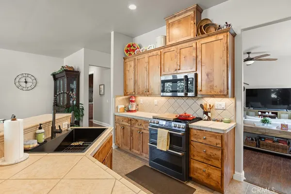 a kitchen that has a sink and a stove top oven