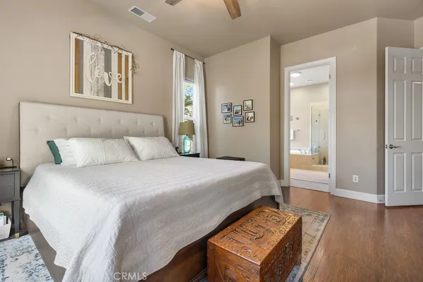 a bedroom with a bed and a night stand