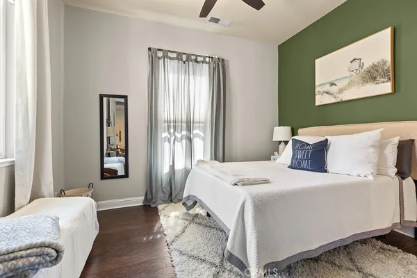 a bedroom with a bed and a painting on the wall