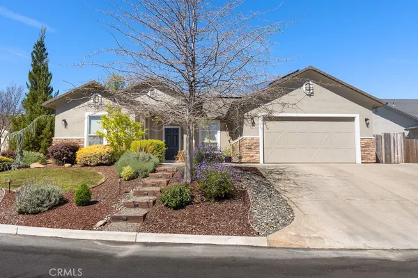 a front view of a house with garden