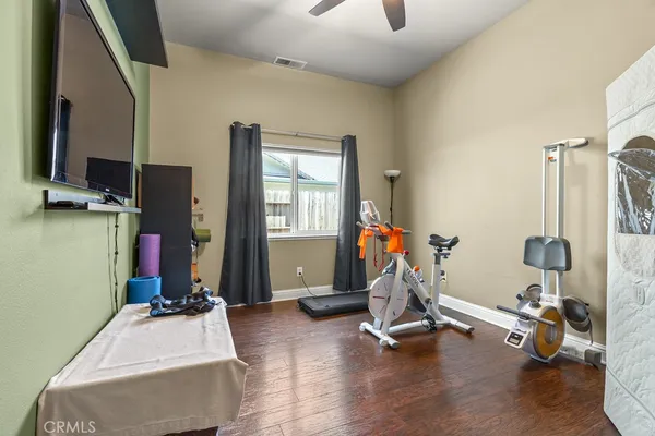 a room with gym equipment and a flat screen tv