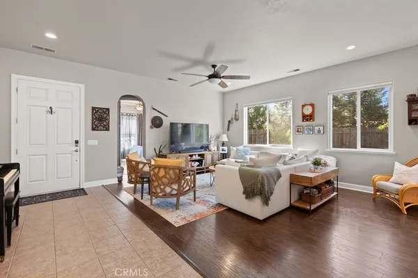 a living room with furniture a large window and a chandelier