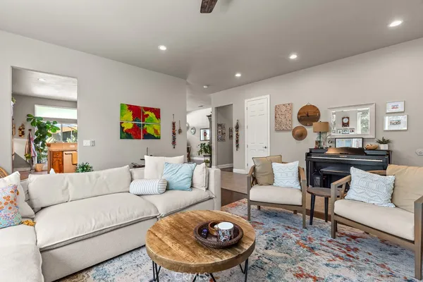 a living room with furniture and wooden floor