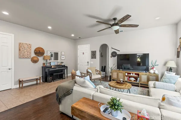 a living room with furniture a fireplace and a flat screen tv