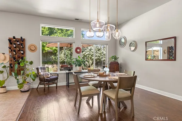 a view of a dining room with furniture wooden floor and chandelier