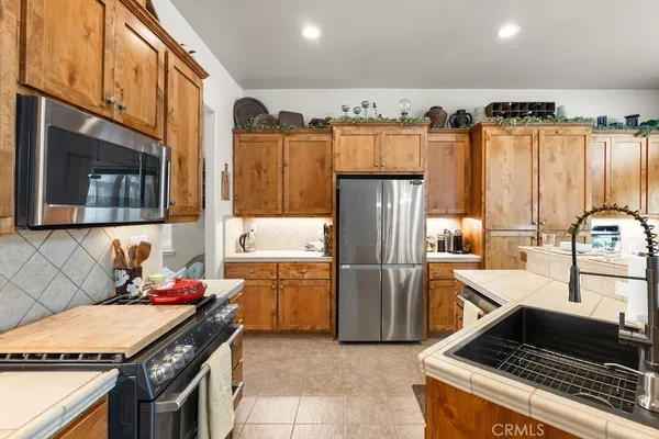 a kitchen with refrigerator and cabinets
