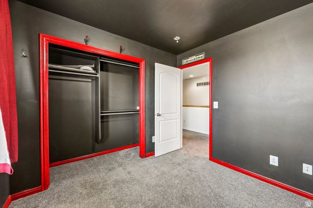 3215 West 450 North West Point, UT 84015 - Photo 20 of 40 Room featuring dark gray walls, red trim, and gray carpet flooring