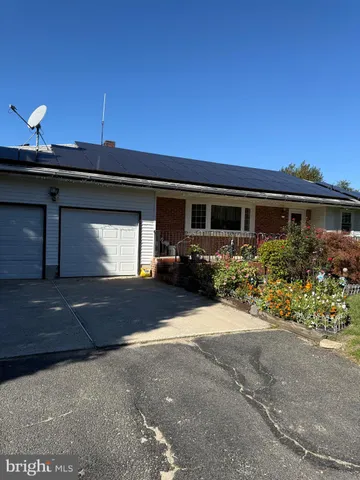 a front view of a house with a yard and a garage