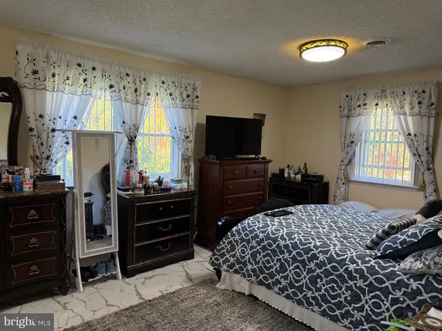 a bedroom with a bed and a television