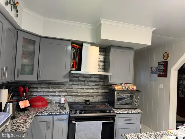 a kitchen with stainless steel appliances granite countertop a stove and a sink