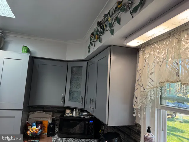 a living room with a large window and a fireplace