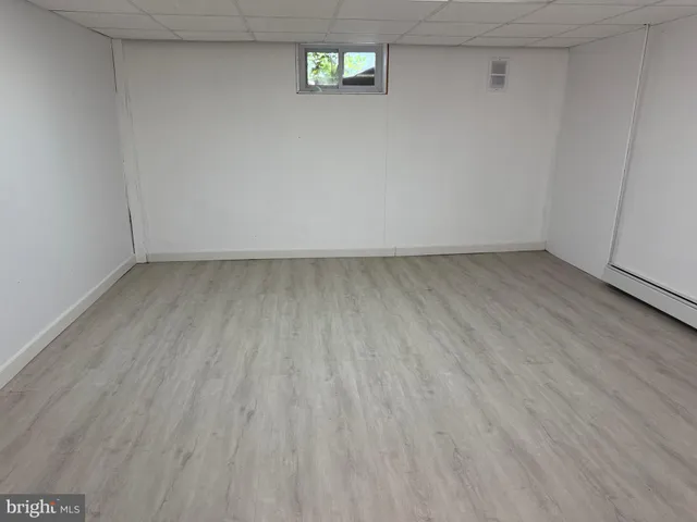 a view of an empty room and wooden floor