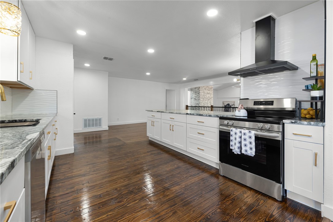 1012 East Main Street Sinton, TX 78387 - Photo 12 of 34 a kitchen with stainless steel appliances granite countertop a stove a sink and a refrigerator