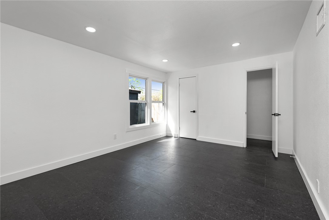 1012 East Main Street Sinton, TX 78387 - Photo 20 of 34 an empty room with wooden floor and windows