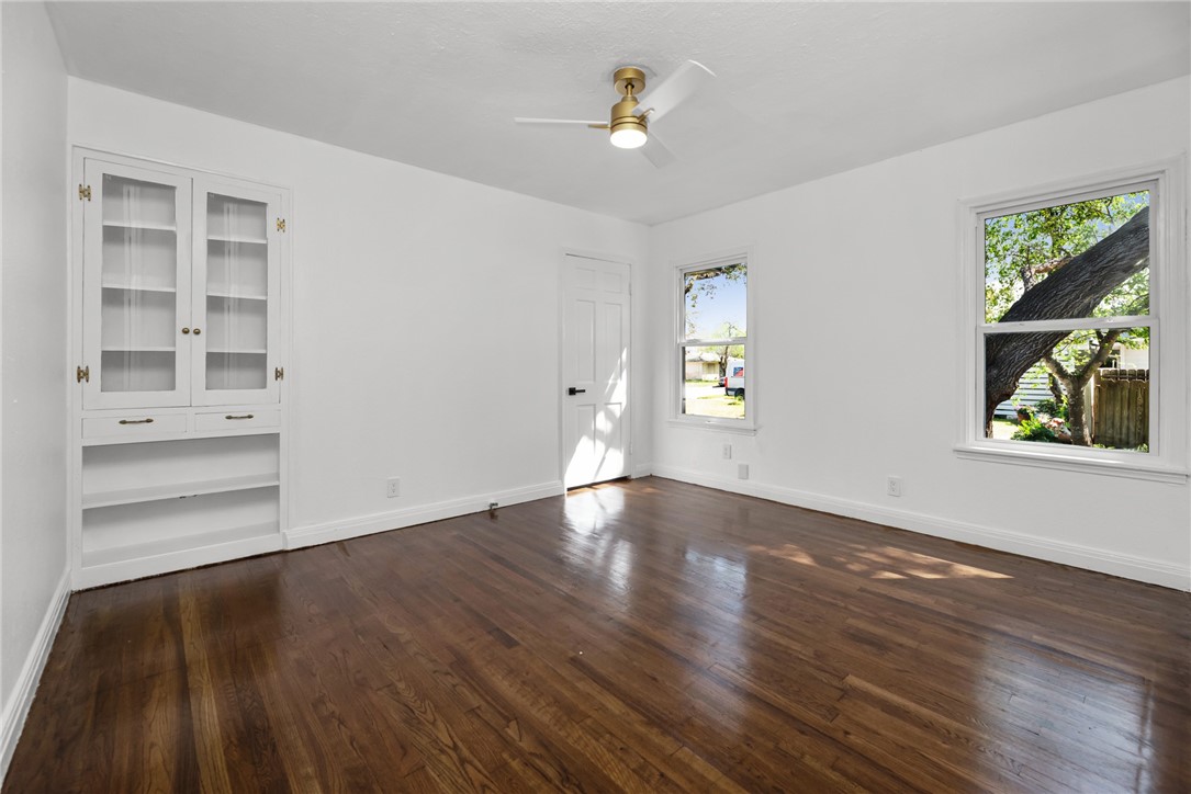 1012 East Main Street Sinton, TX 78387 - Photo 24 of 34 wooden floor in an empty room with a window