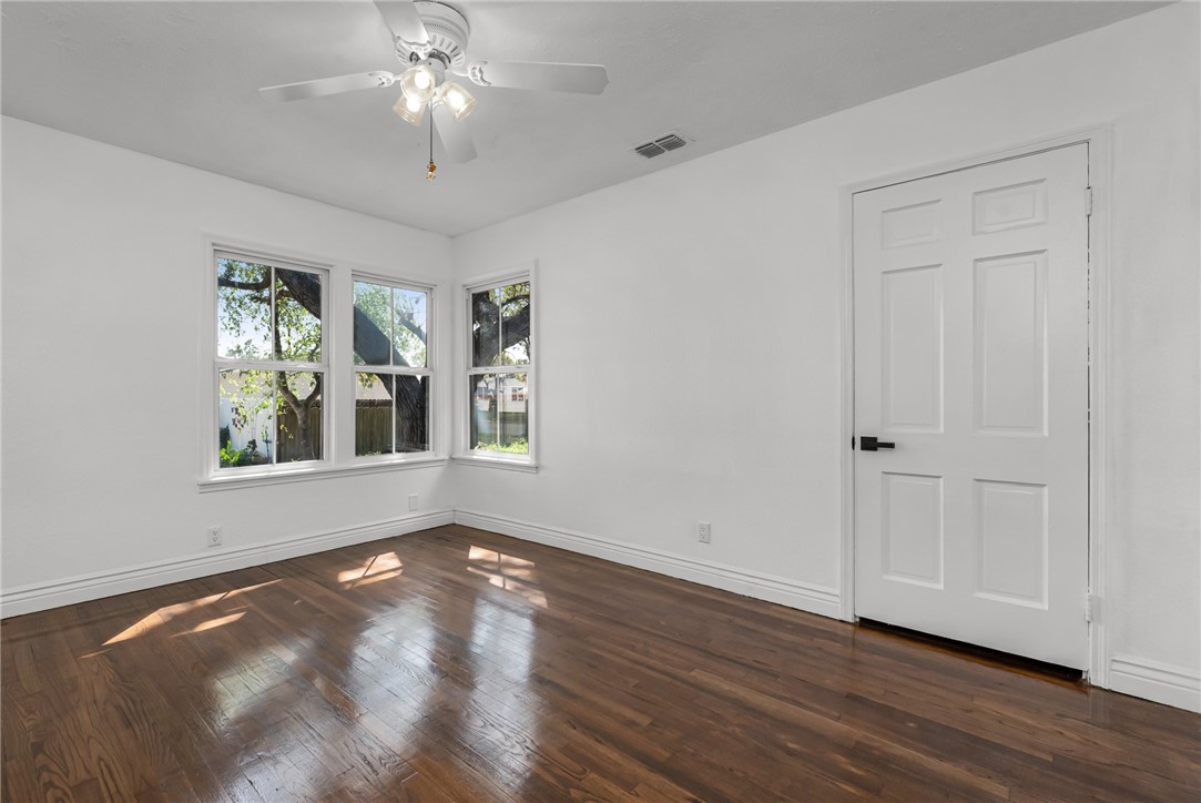1012 East Main Street Sinton, TX 78387 - Photo 26 of 34 a view of an empty room with wooden floor and a window