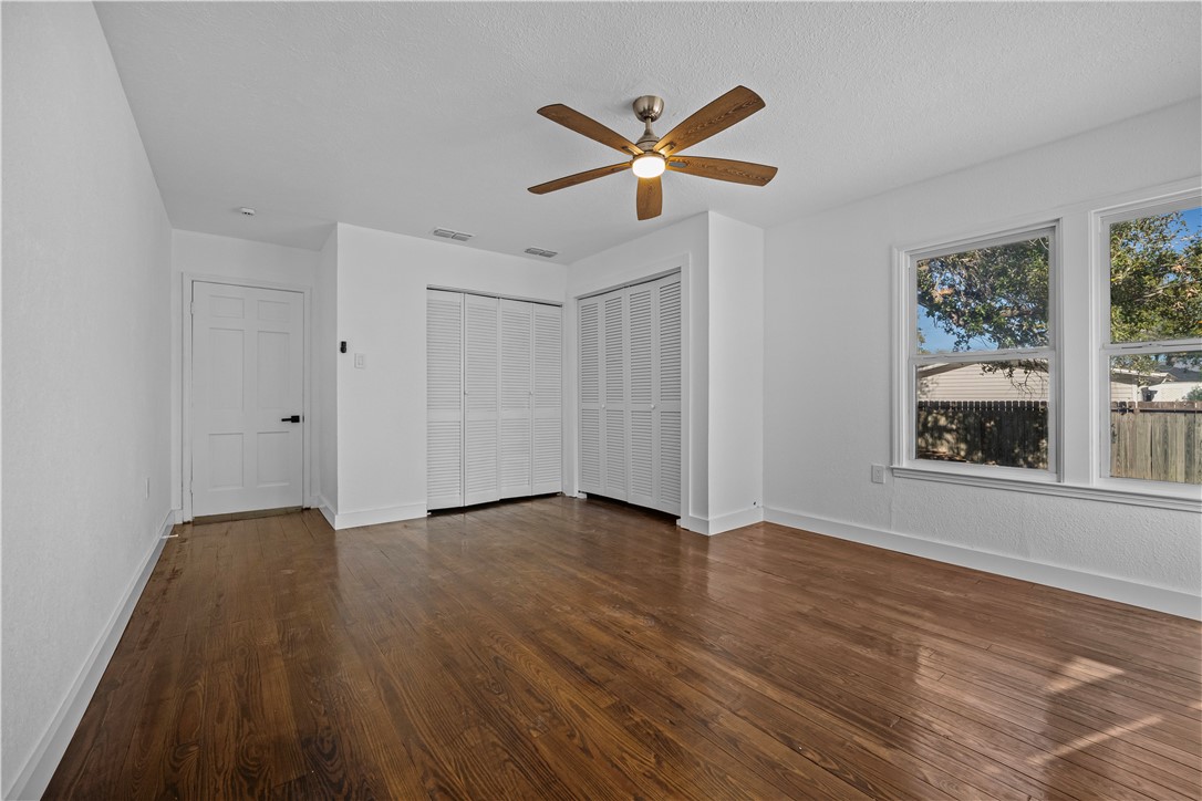 1012 East Main Street Sinton, TX 78387 - Photo 29 of 34 a view of an empty room with wooden floor and a window