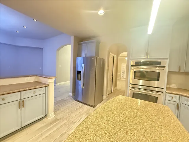 a view of a kitchen with a sink and wooden floor