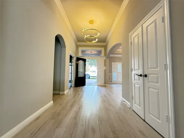 a view of a hallway with wooden floor