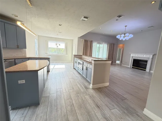 a kitchen with a sink and wooden floor