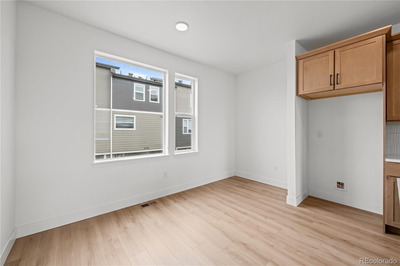2736 West 68th Avenue Denver, CO 80221 - Photo 21 of 44 a view of an empty room with wooden floor and a window