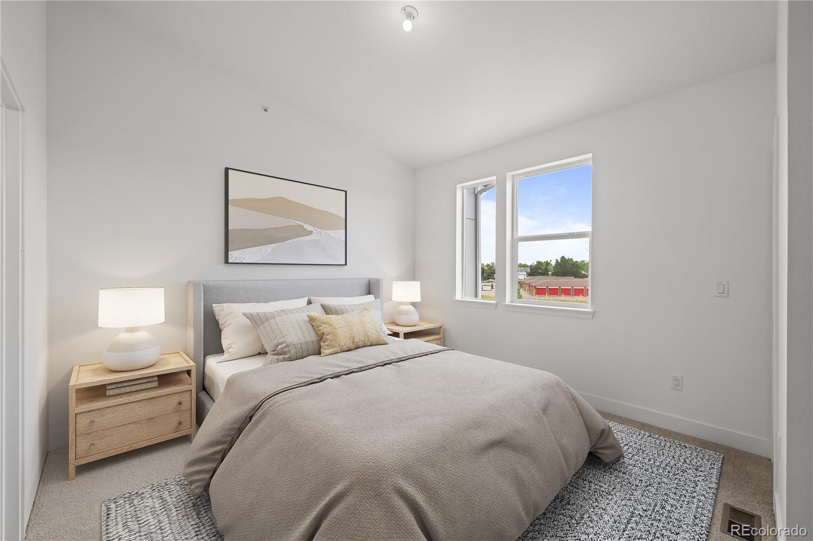 2736 West 68th Avenue Denver, CO 80221 - Photo 22 of 44 a bedroom with a bed and a painting on the wall